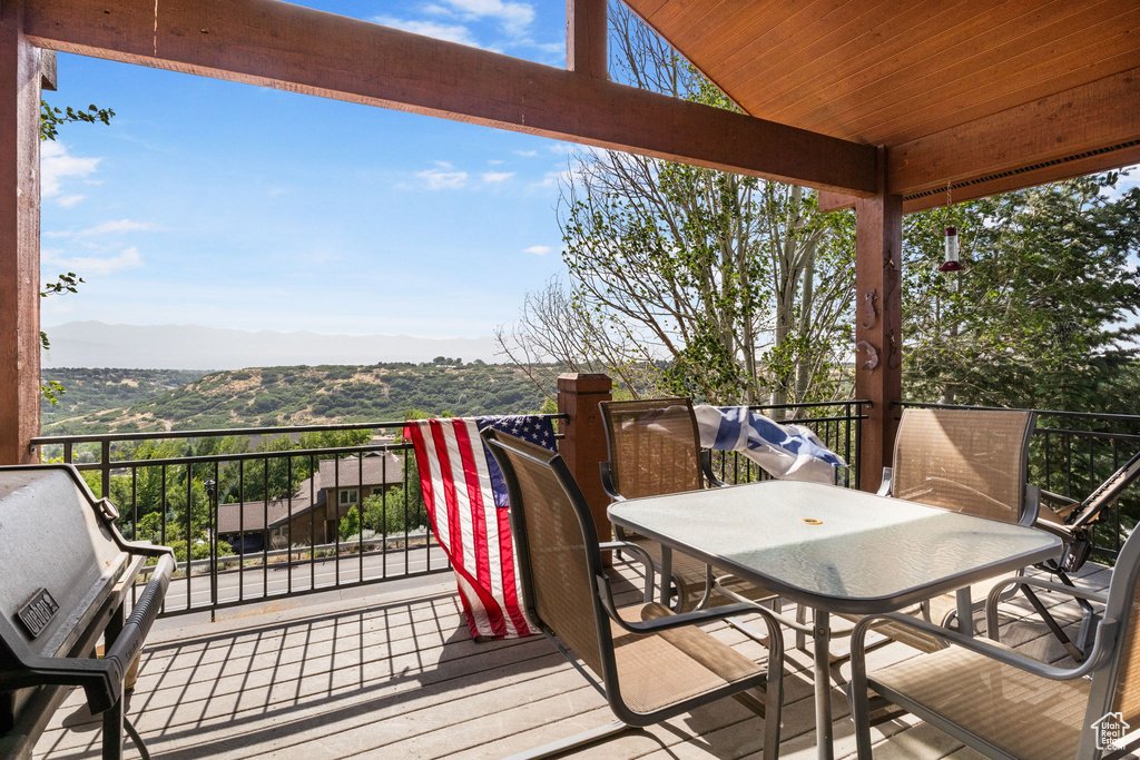 Wooden terrace with a mountain view and outdoor dining area