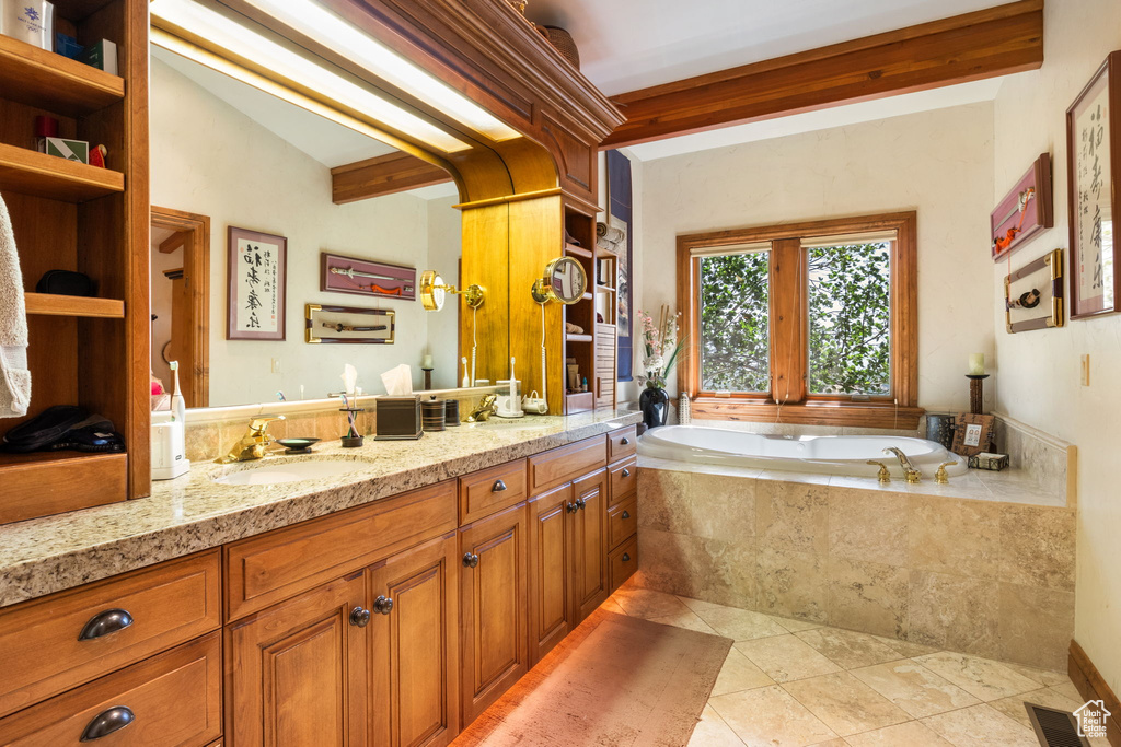 Full bathroom with vanity, a bath, and tile patterned floors