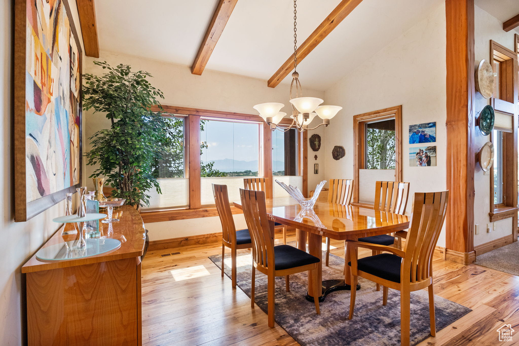 Dining room featuring light wood-style flooring and a chandelier