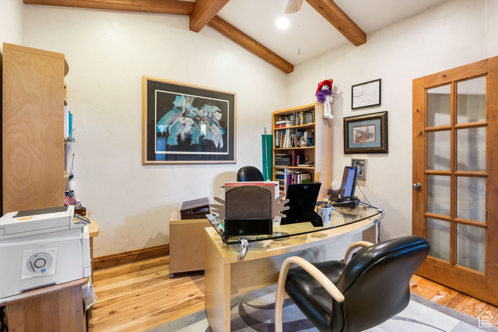 Office with light wood-style floors and baseboards