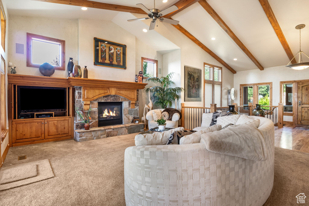 Living room featuring recessed lighting, a fireplace, ceiling fan, and carpet flooring