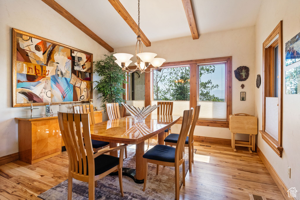 Dining space featuring light wood-type flooring and a chandelier