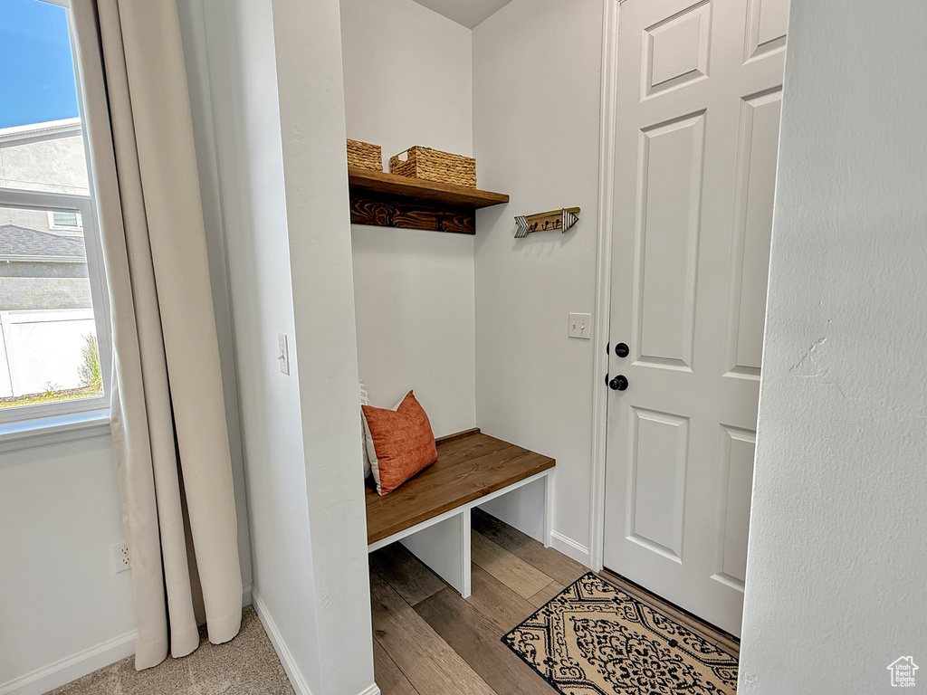 Mudroom featuring baseboards and wood finished floors