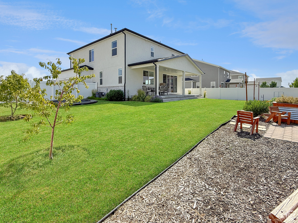 Rear view of property with a patio and stucco siding