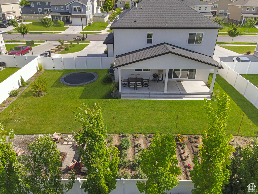 Rear view of property featuring a residential view, stucco siding, and a fenced backyard