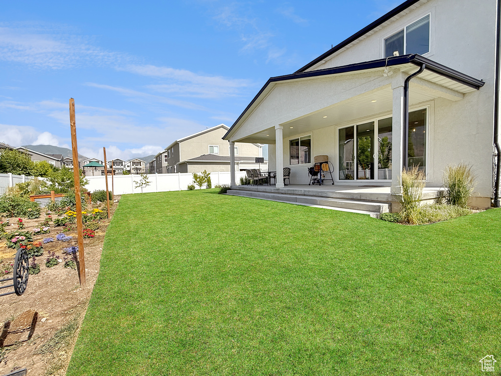 Rear view of property with a patio, stucco siding, and a residential view