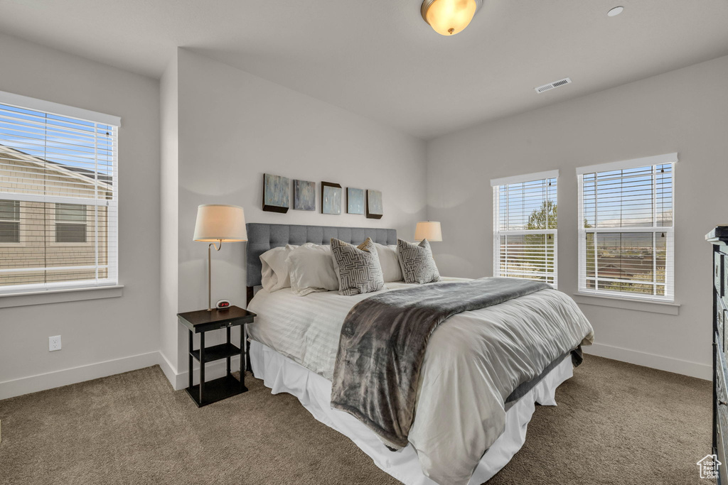 Carpeted bedroom featuring baseboards