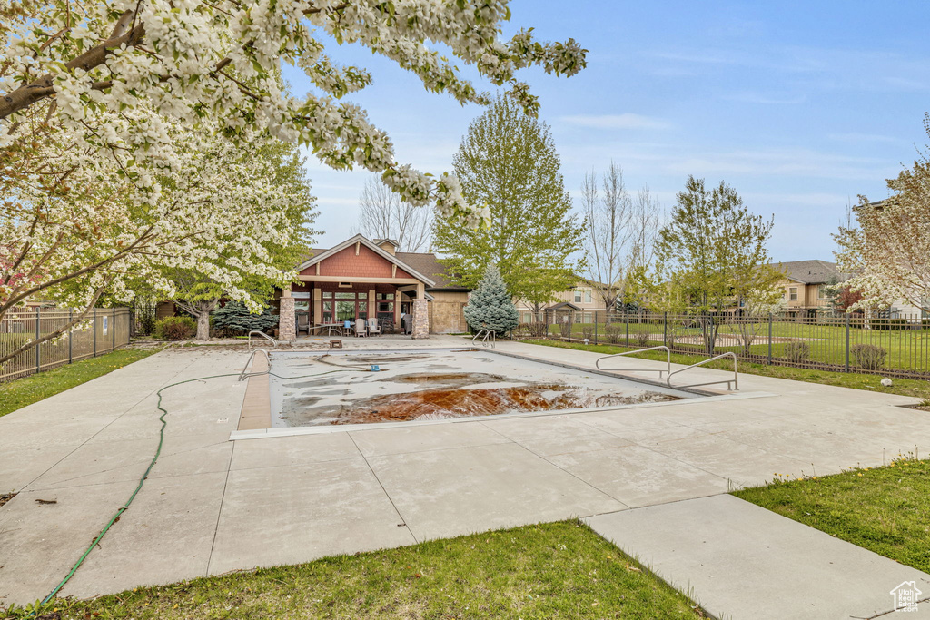 Surrounding community with a pool and a patio area