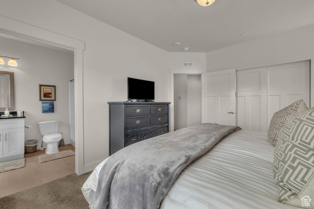 Bedroom featuring a closet and ensuite bathroom