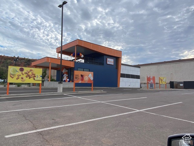 View of property featuring uncovered parking