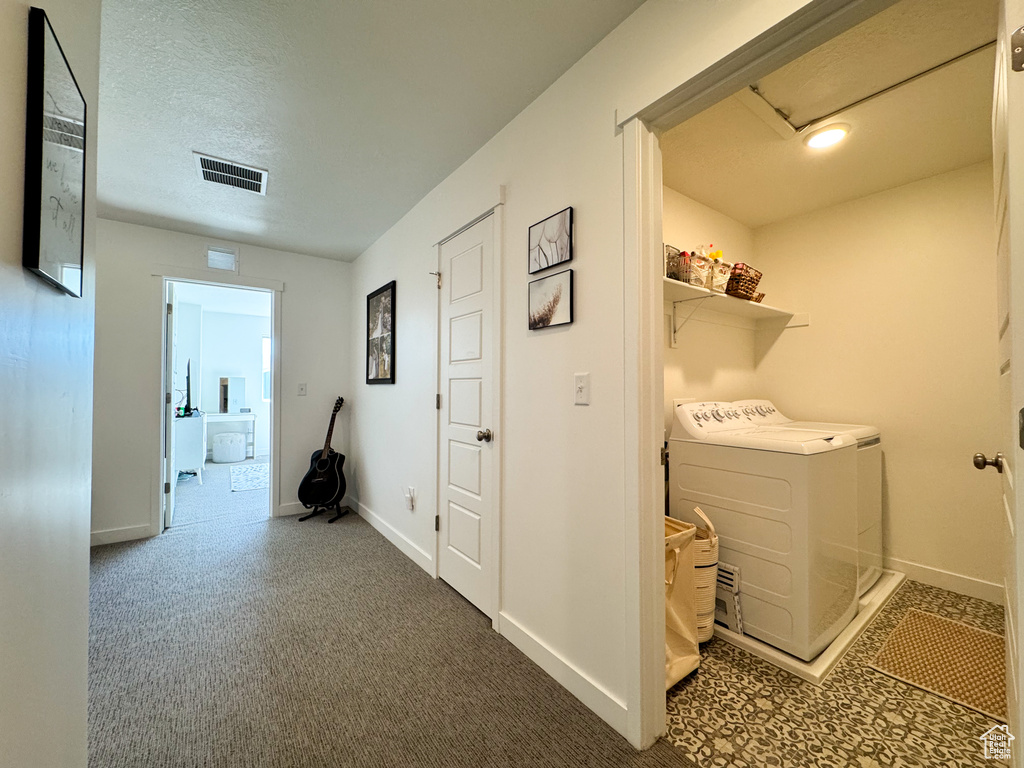 Washroom with washer and dryer and carpet