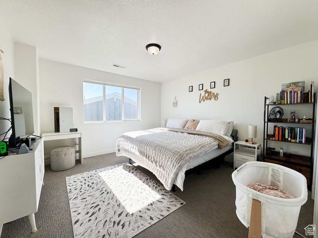 Carpeted bedroom featuring baseboards