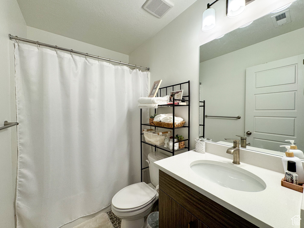 Bathroom with vanity and a shower with shower curtain