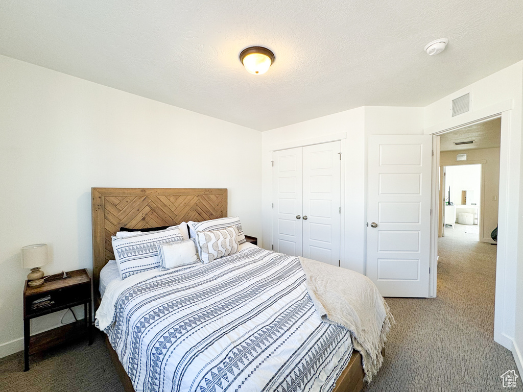 Bedroom featuring carpet flooring and a closet