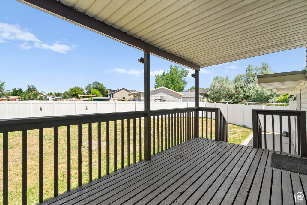 Wooden terrace with a fenced backyard and a residential view