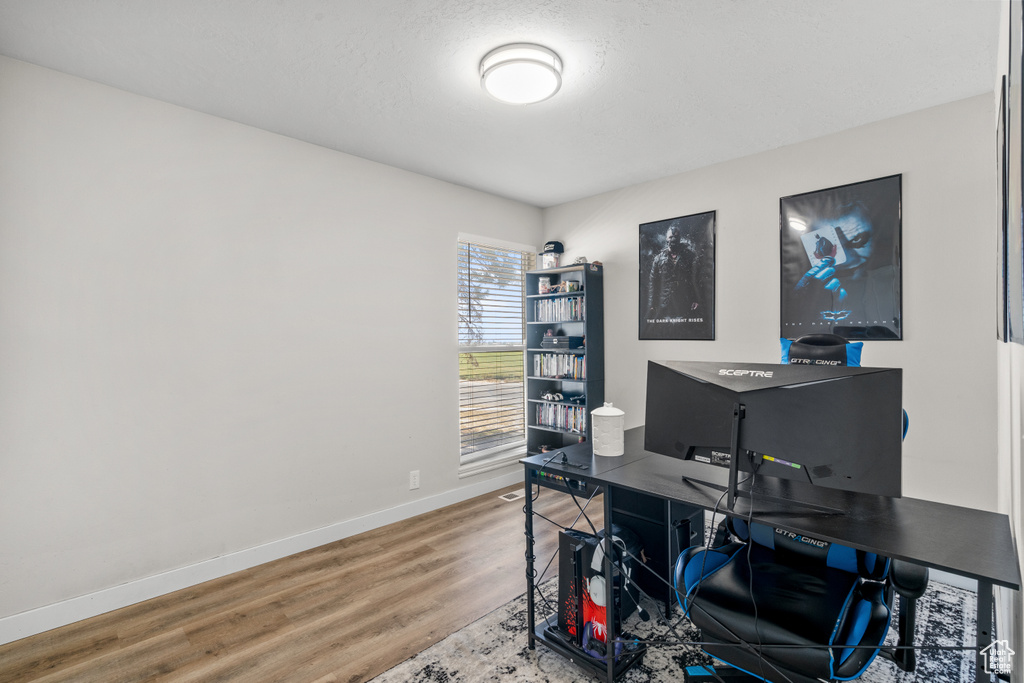 Office space featuring baseboards and wood finished floors
