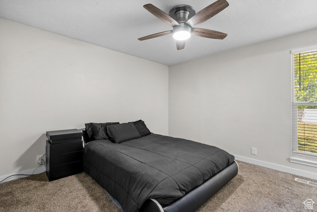 Bedroom featuring carpet flooring and a ceiling fan