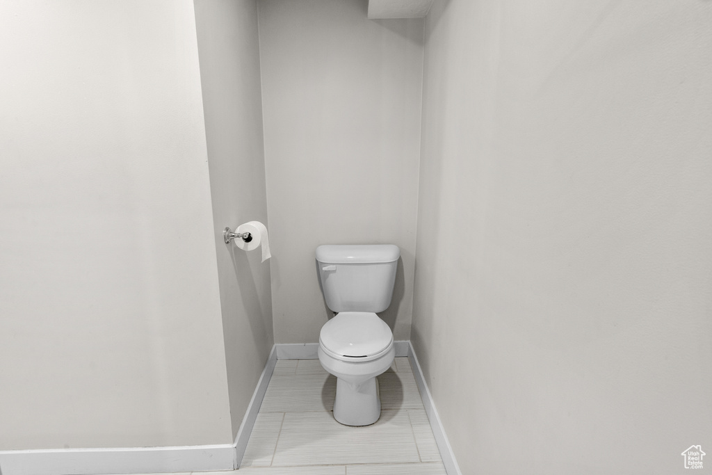 Bathroom with toilet and baseboards