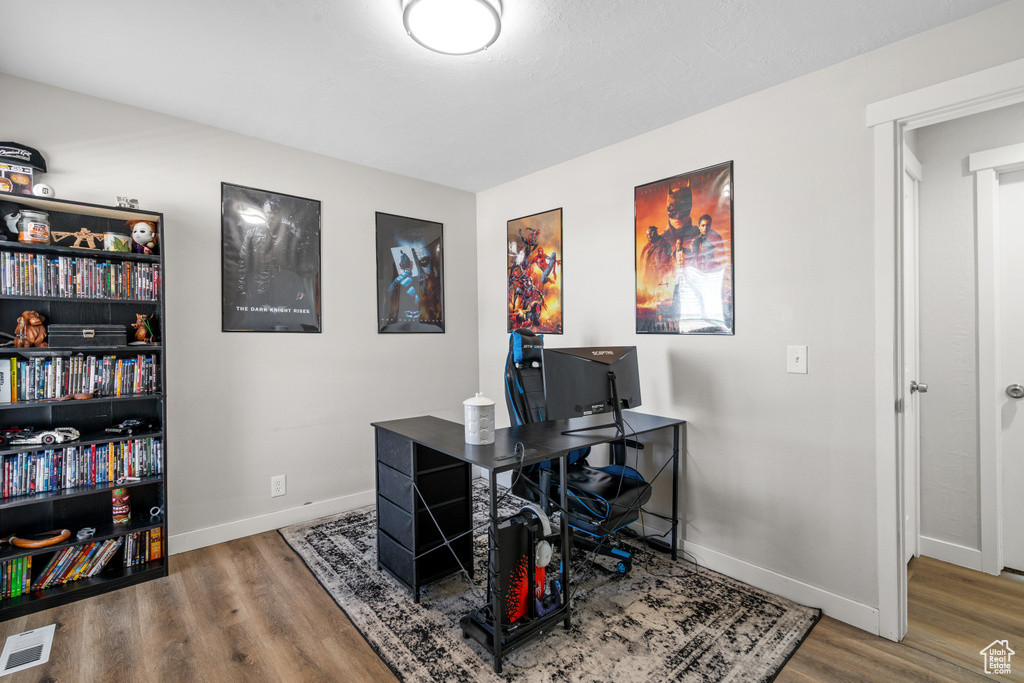 Office space with wood finished floors and baseboards