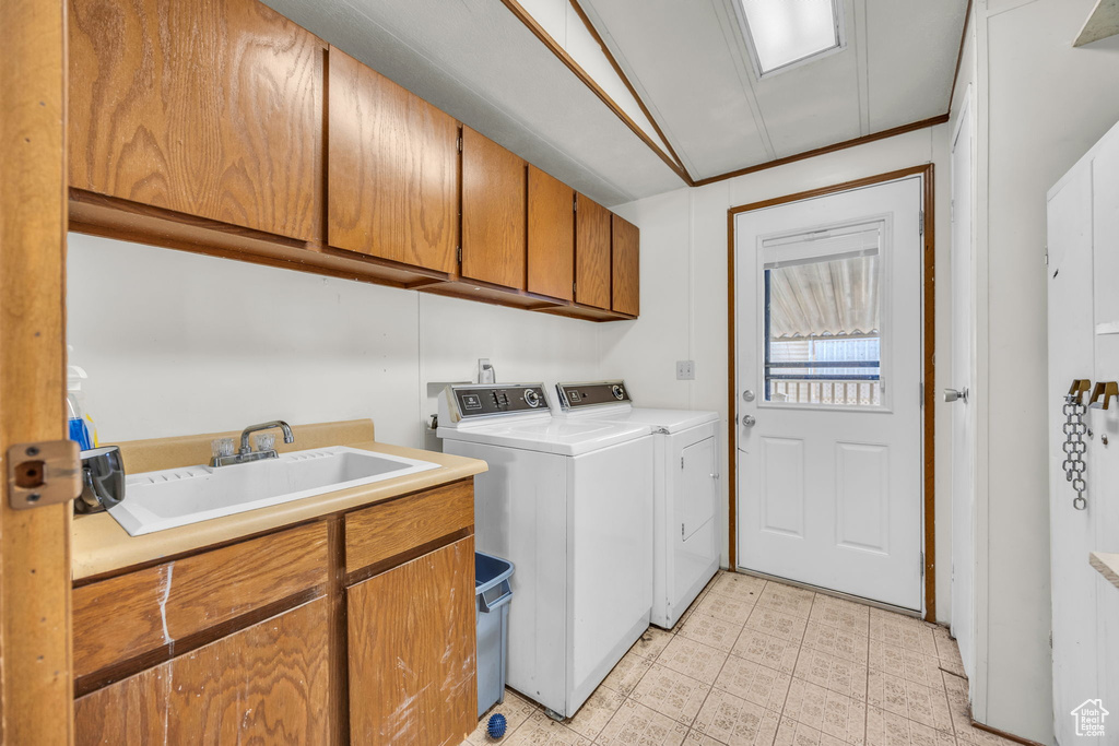 Laundry area with cabinet space, washer and clothes dryer, and light tile patterned flooring