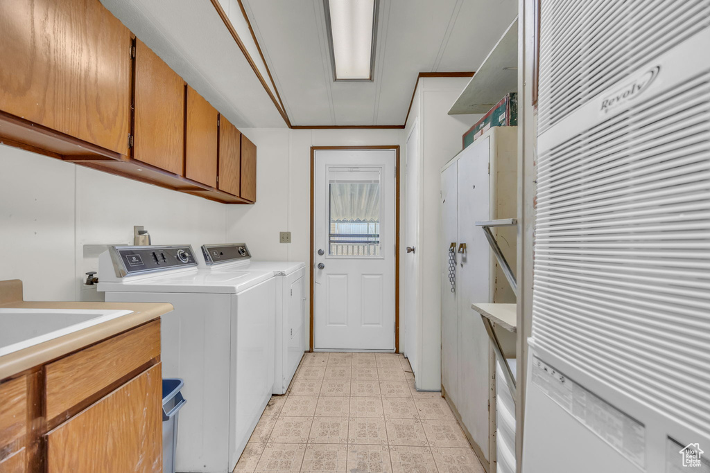 Washroom with cabinet space and independent washer and dryer