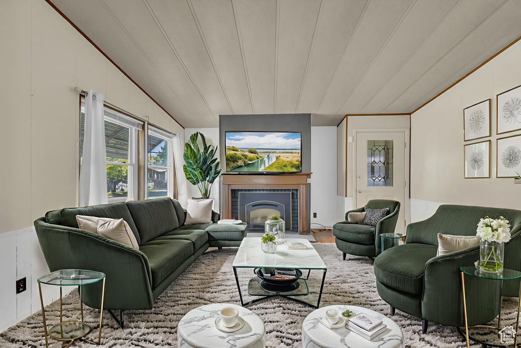 Living room with lofted ceiling and a tile fireplace