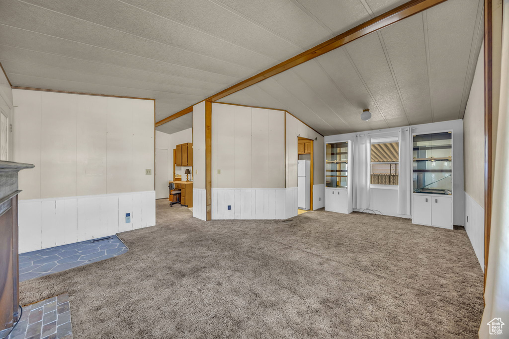 Unfurnished living room with carpet floors and a fireplace