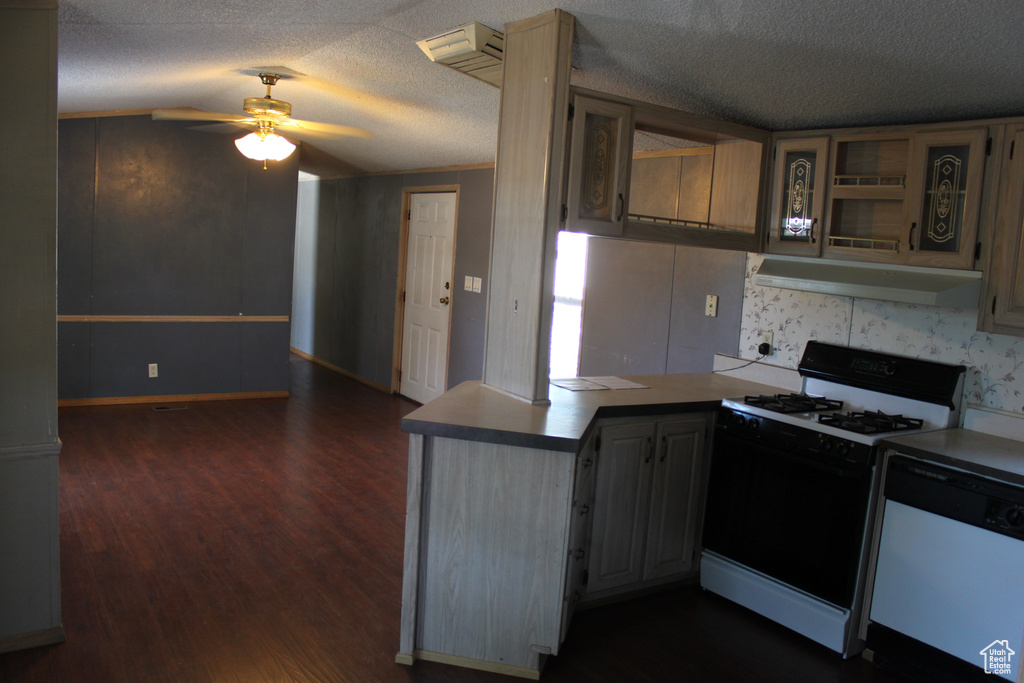 Kitchen with gas range, dishwasher, under cabinet range hood, a peninsula, and a ceiling fan