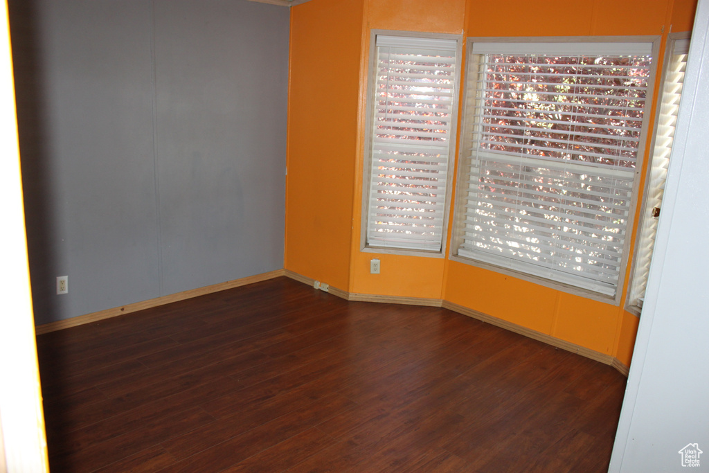 Empty room featuring dark wood-style flooring