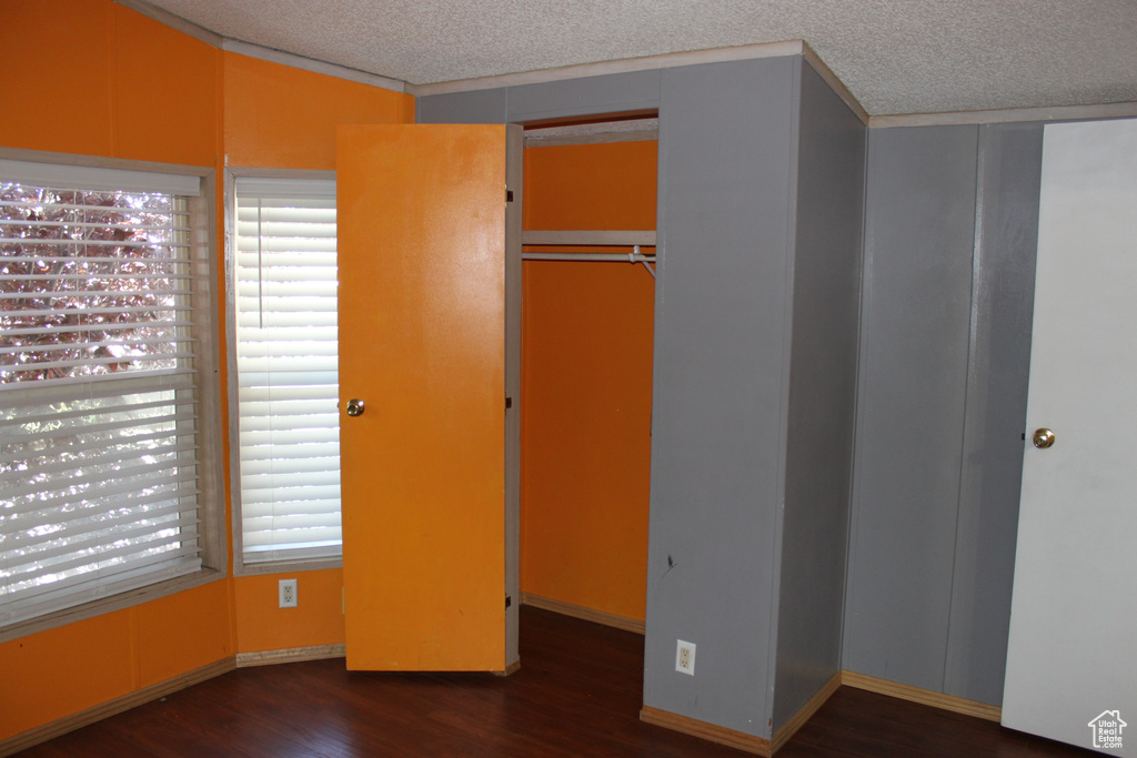 Unfurnished bedroom featuring wood finished floors and a textured ceiling