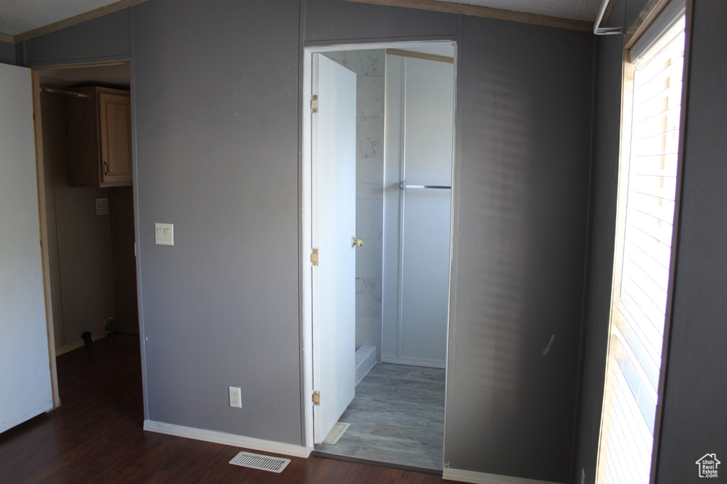 Corridor featuring wood finished floors and baseboards