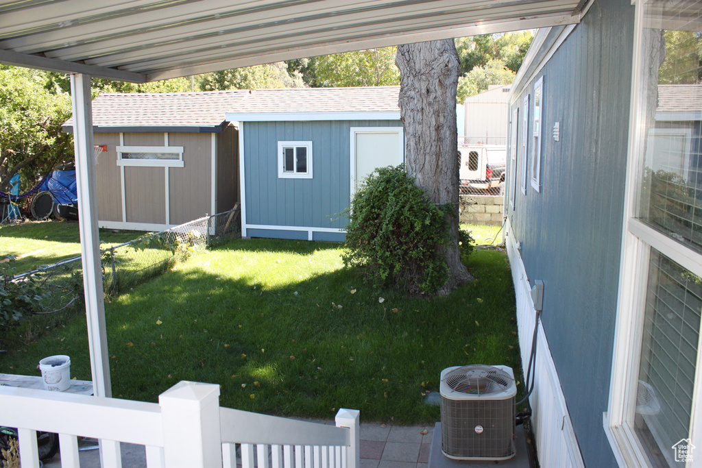 View of green lawn with a storage unit