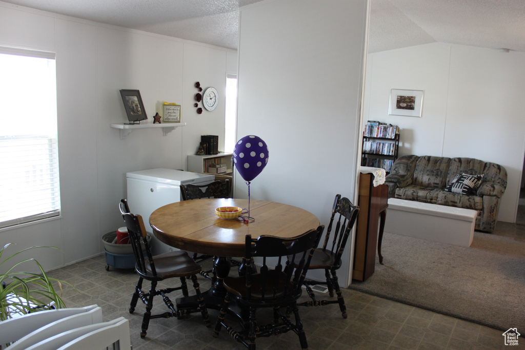 Dining area with lofted ceiling