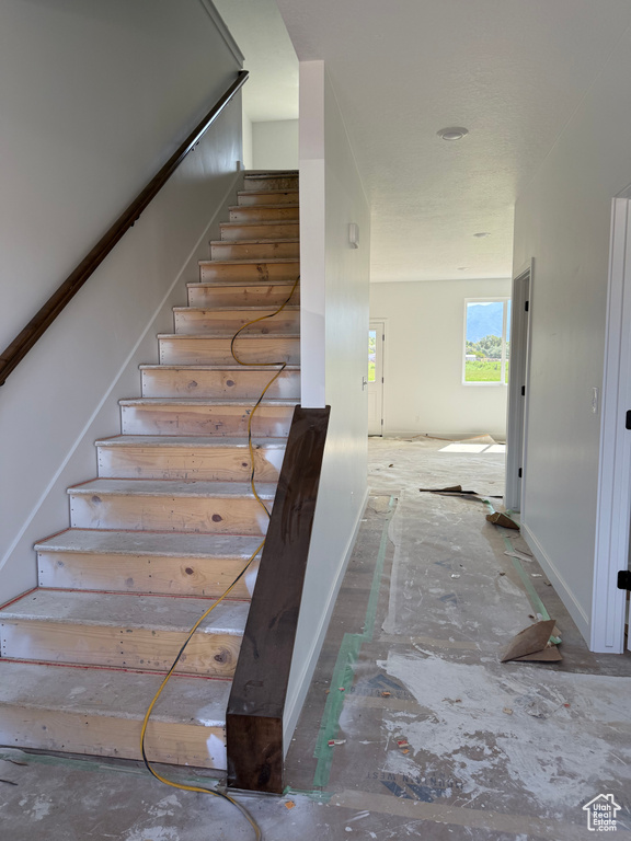 Staircase featuring baseboards