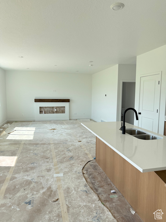 Unfurnished living room featuring a textured ceiling