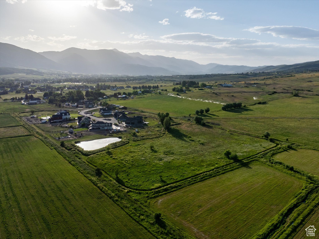 Aerial view of property's location featuring rural landscape and a mountainous background
