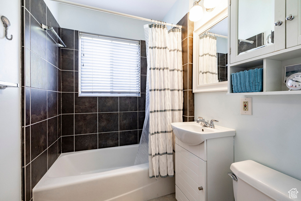 Full bathroom featuring shower / bath combo and vanity
