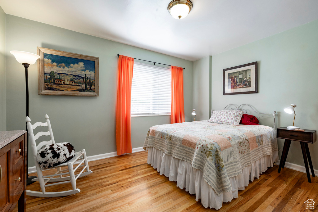 Bedroom featuring light wood finished floors and baseboards