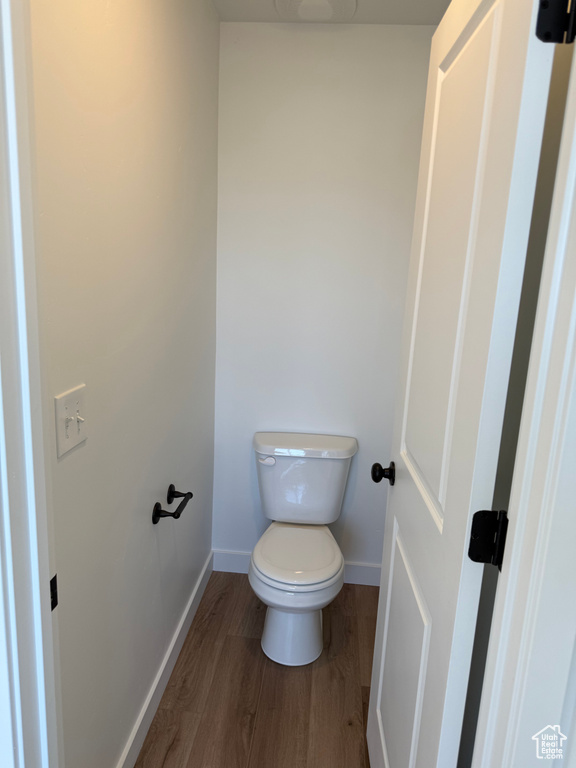 Bathroom featuring baseboards and wood finished floors