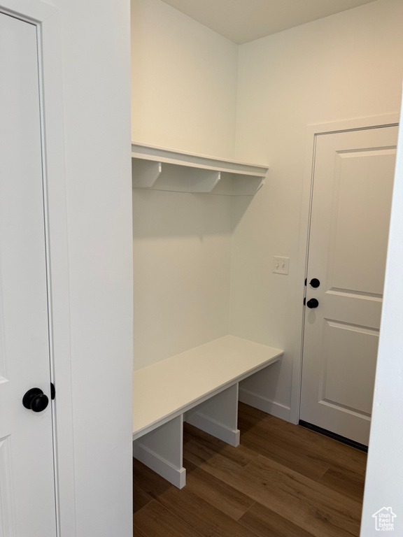 Mudroom with wood finished floors and baseboards