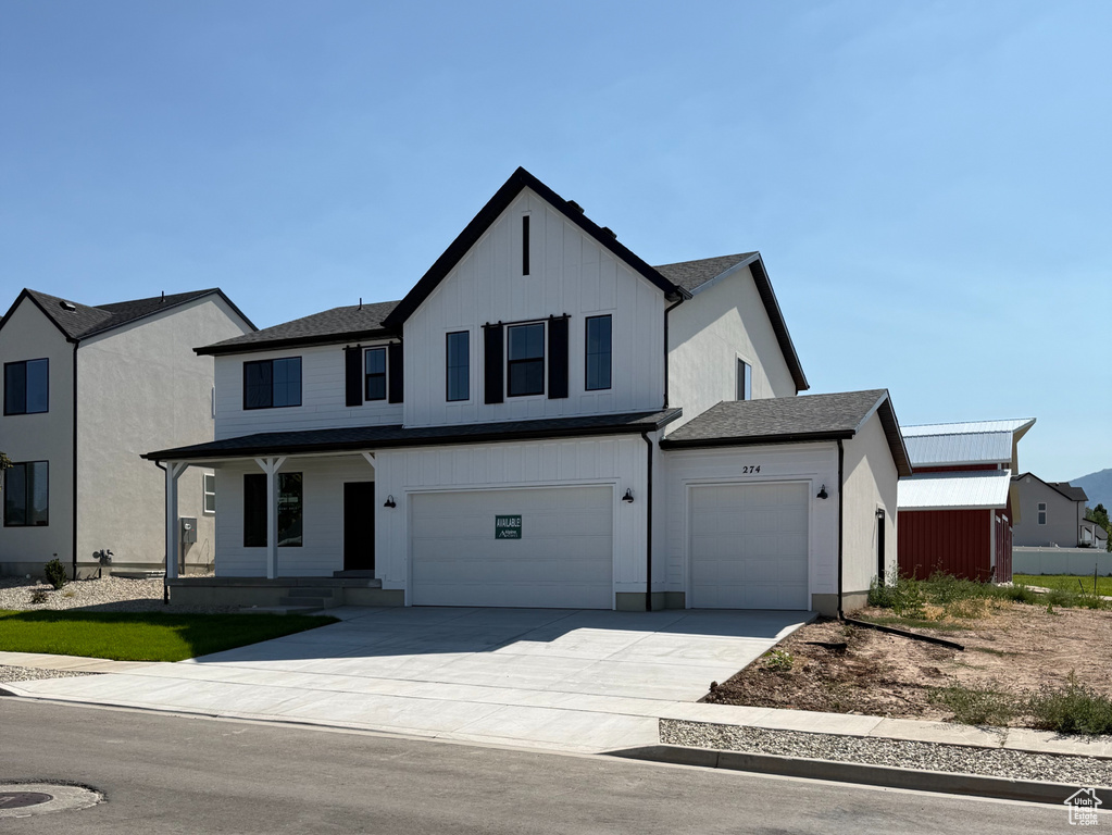 View of front of house with driveway and a garage