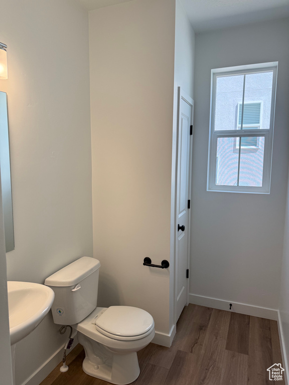 Bathroom featuring wood finished floors and toilet
