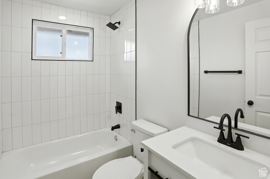 Bathroom with vanity and shower / washtub combination