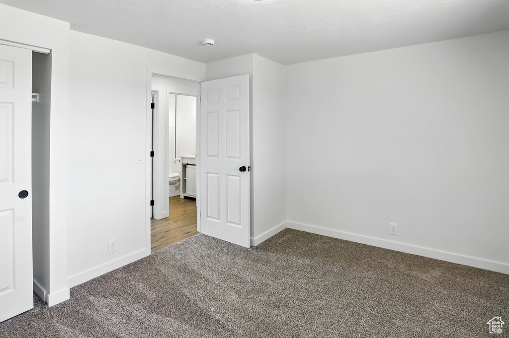 Unfurnished bedroom featuring carpet flooring and baseboards