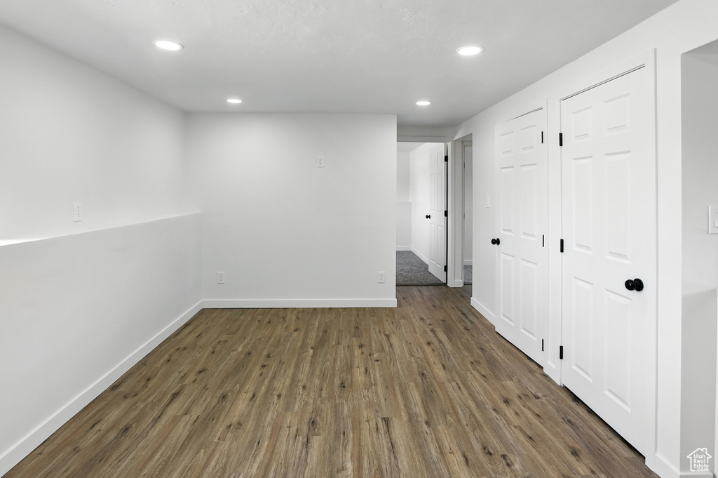 Empty room with wood finished floors and recessed lighting