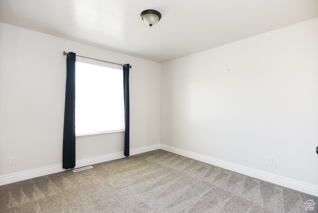 Spare room with carpet flooring and baseboards
