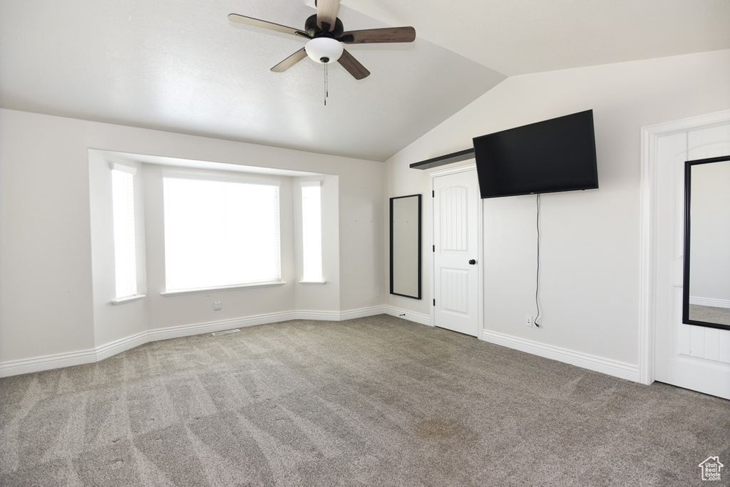 Unfurnished bedroom with vaulted ceiling, carpet flooring, and ceiling fan