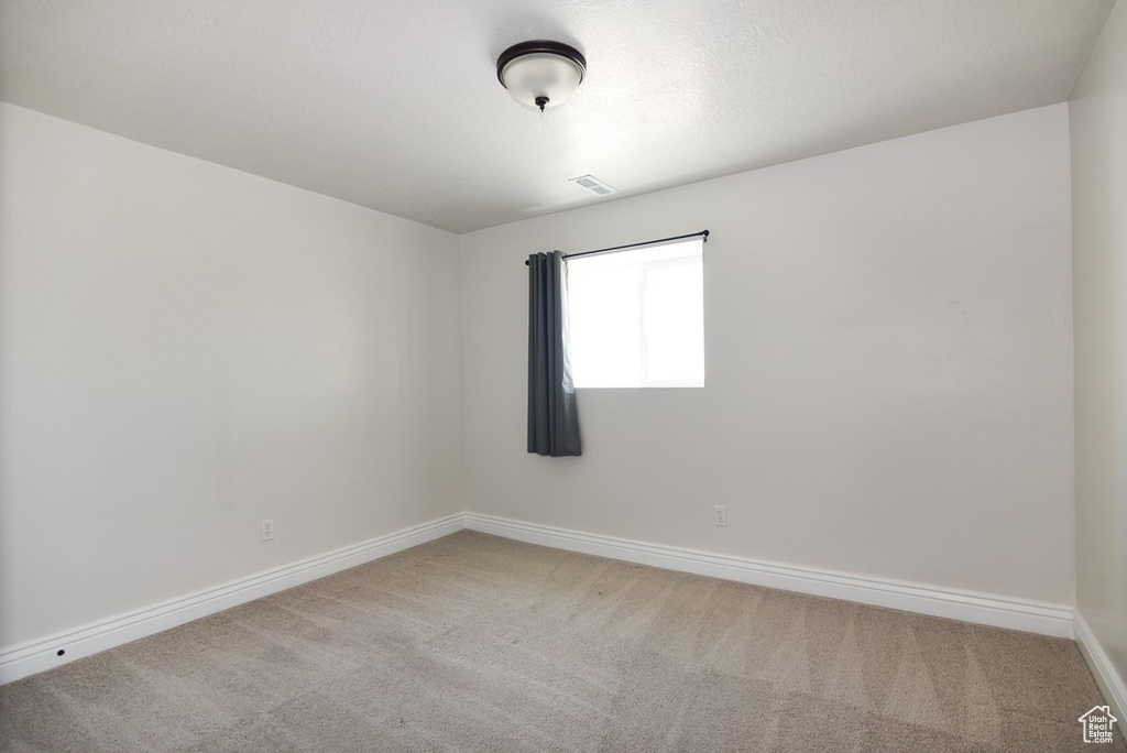 Unfurnished room with light carpet