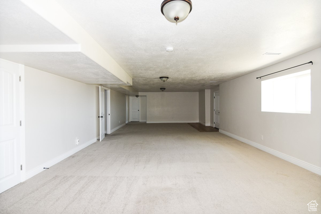 Basement with light colored carpet