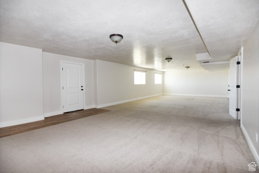Below grade area featuring carpet and baseboards